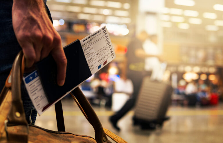 Hand holding boarding pass at the airport