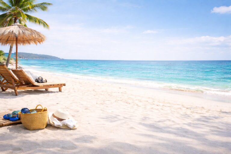 Serene beach setting with palm trees and beach chairs on sandy beach
